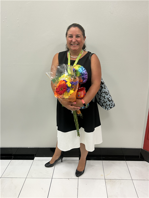 photo of Dr. Claire Norris with bouquet of flowers